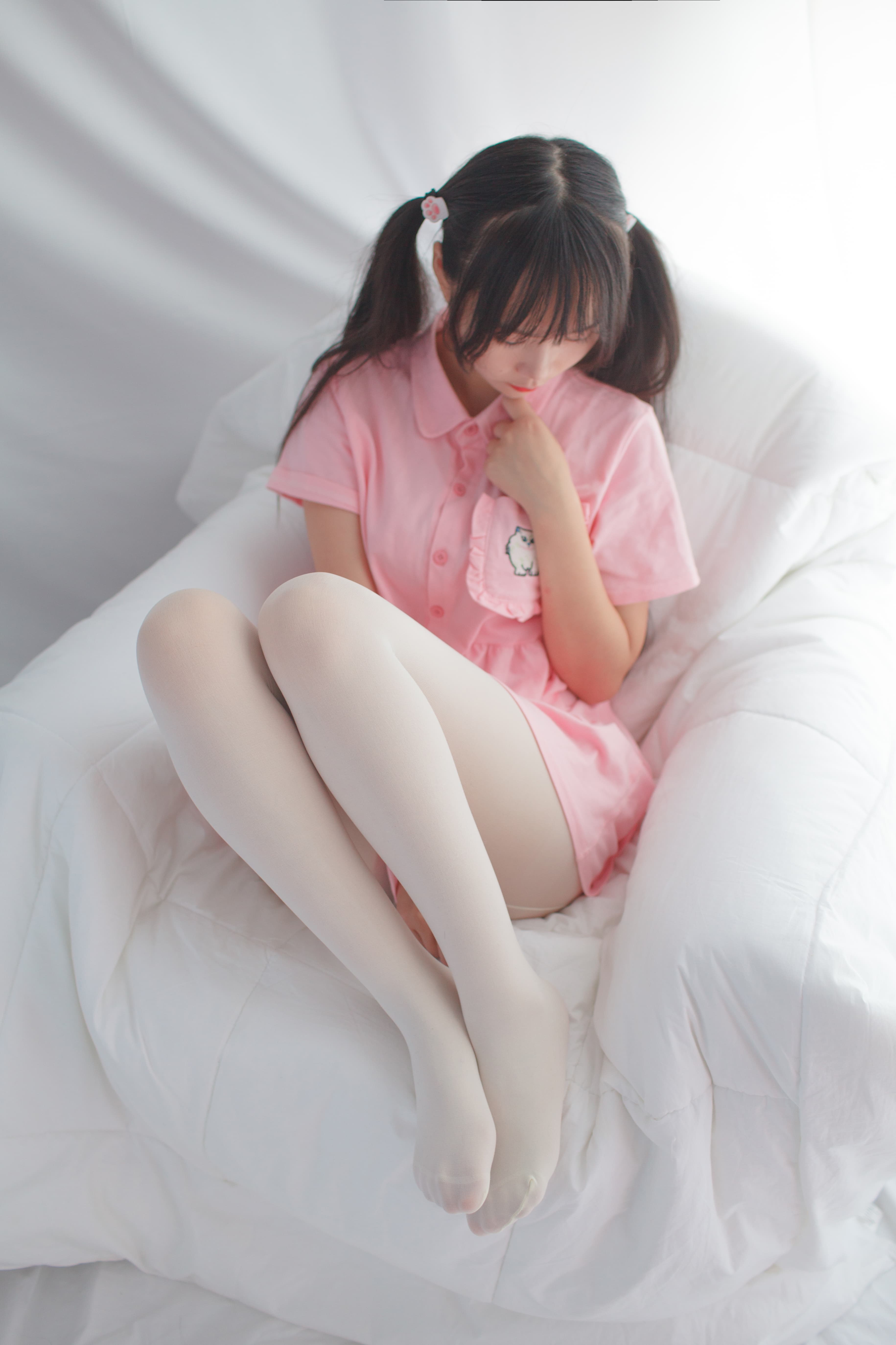 Playful scene of pink-accented stockings sliding down to reveal a bare foot arch